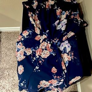 I’m selling a blue floral romper that flows down in the back.